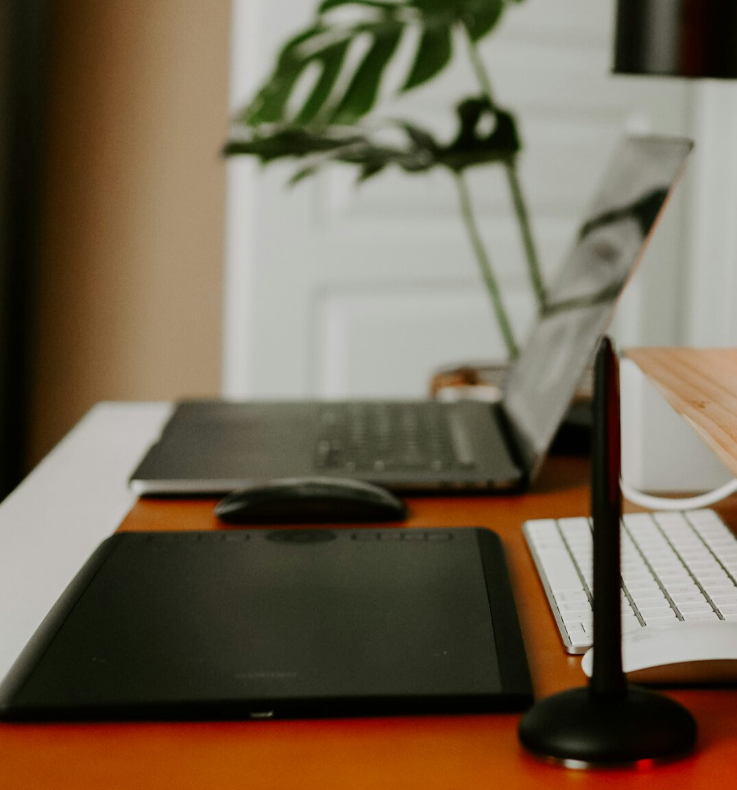 Entrepreneur signing company incorporation documents next to a laptop